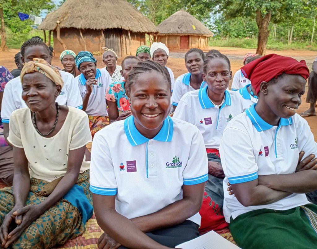 woman former child soldier smiling in northern uganda, grassroots reconciliation group